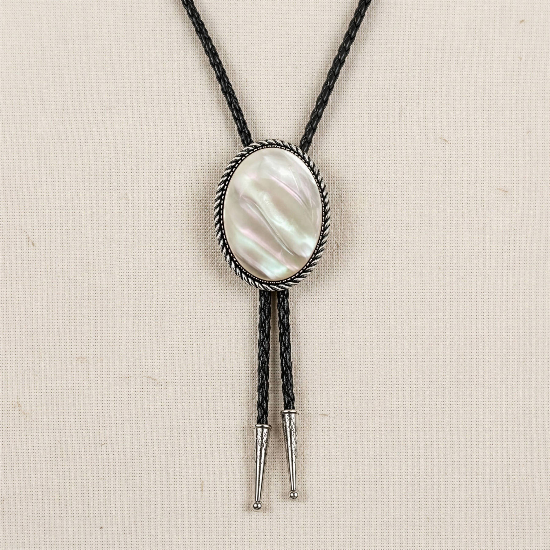 mesathread-white-mother-of-pearl-oval-western-bolo-tie-black-braided-cord-front-view