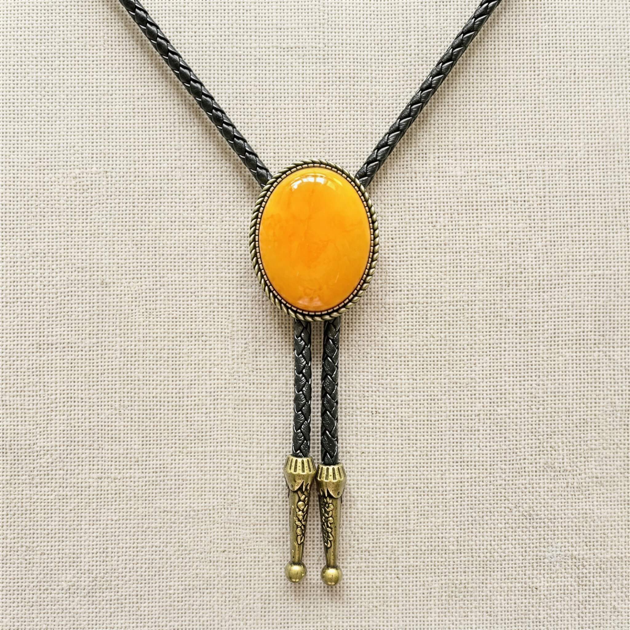mesathread-amber-yellow-oval-western-bolo-tie-black-braided-cord-front-view