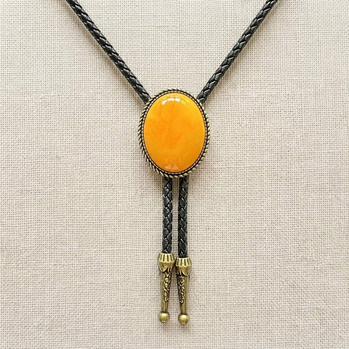 mesathread-amber-yellow-oval-western-bolo-tie-black-braided-cord-front-view