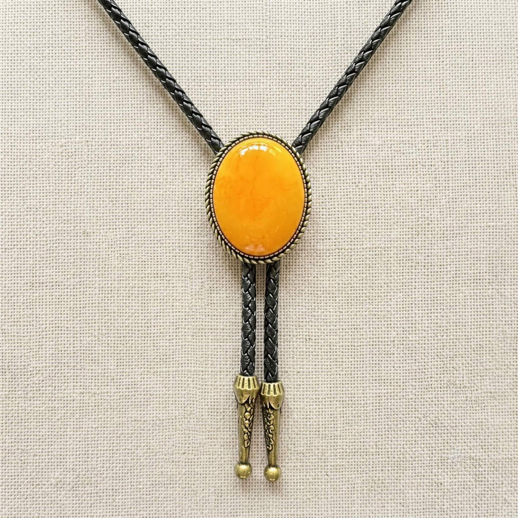 mesathread-amber-yellow-oval-western-bolo-tie-black-braided-cord-front-view