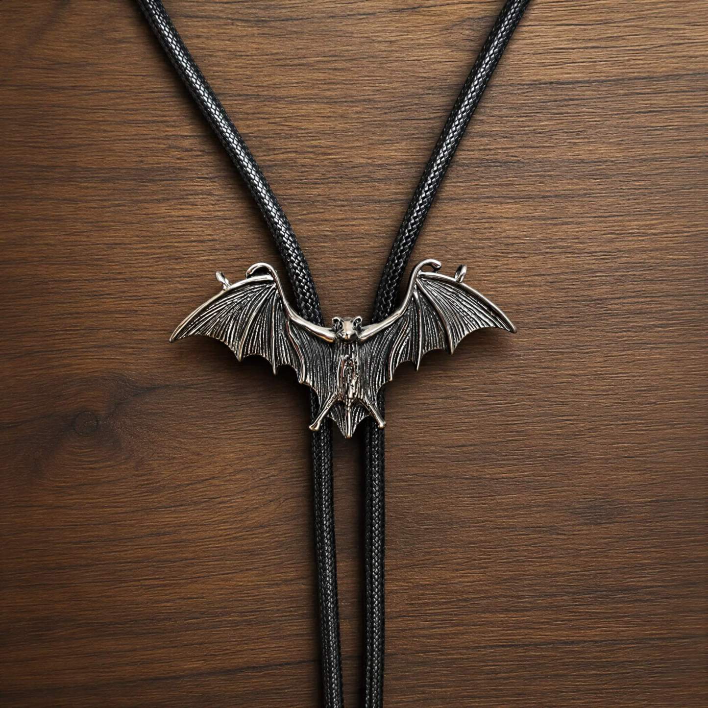 mesathread-sculpted-flying-bat-antique-silver-western-gothic-bolo-tie-black-cord-front-view