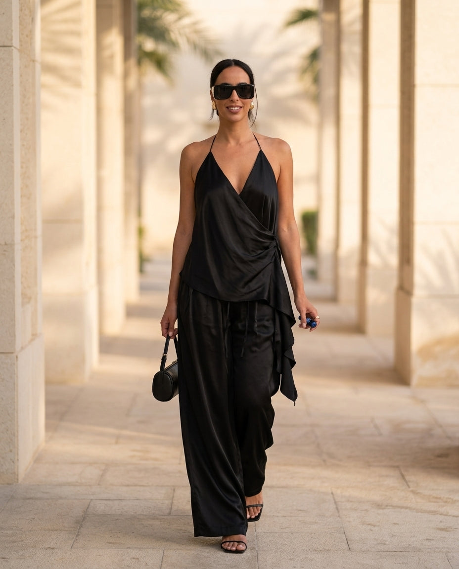 Black Velvet Evening Satin Pant Set Black Pant Set with Asymmetric silhouette and Satin texture, lifestyle scene image for Resort Wear, Brunch in SoHo, US Coastal Glam by Massicos