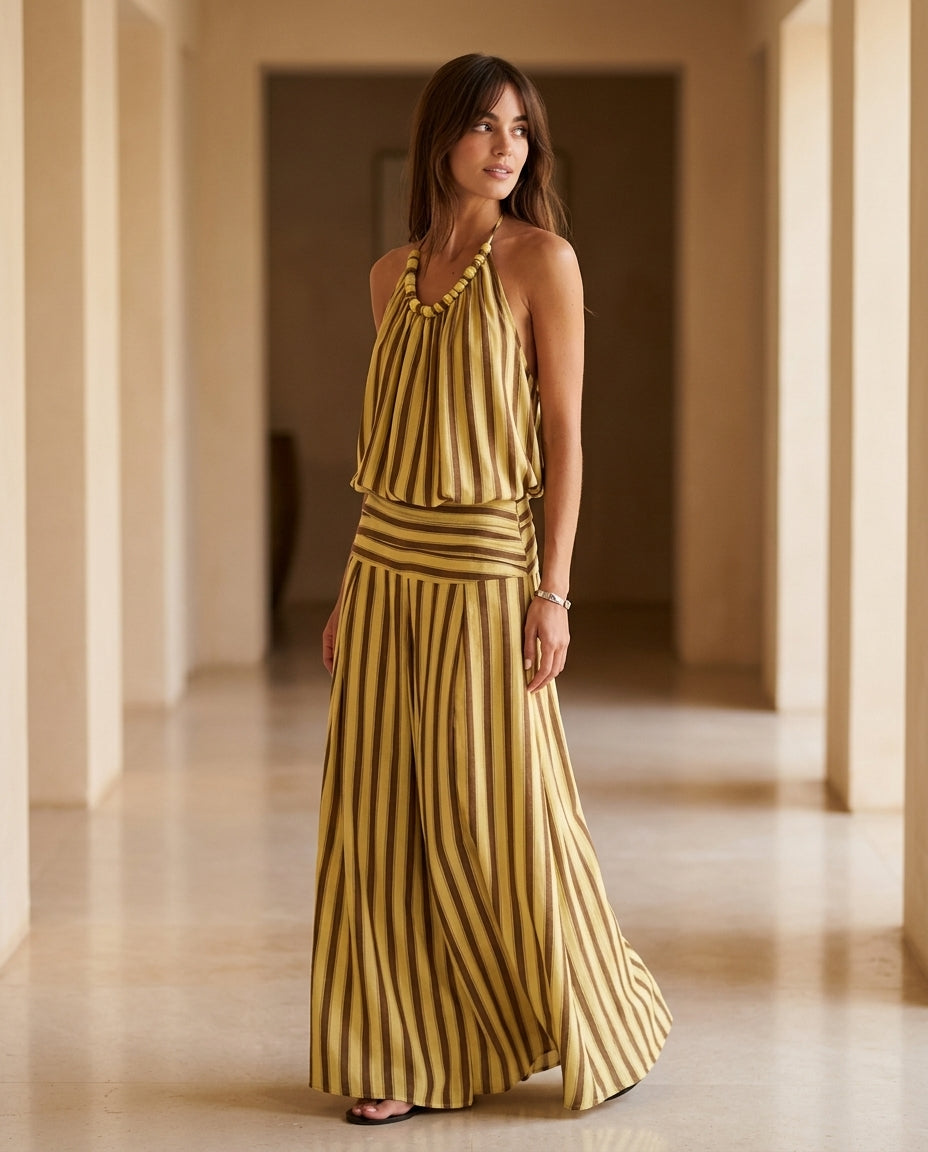 Butter Yellow Charm Resort Striped Romper Butter Yellow Romper with Relaxed Fit silhouette and Textured texture, editorial ecommerce scene for Resort Wear, an estate dinner at golden hour, US East / Hamptons Elite by Massicos