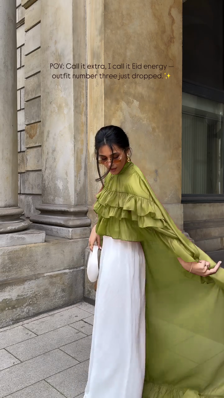 Ruffled cape-style top paired with wide-leg pants suit