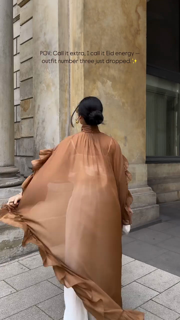 Ruffled cape-style top paired with wide-leg pants suit