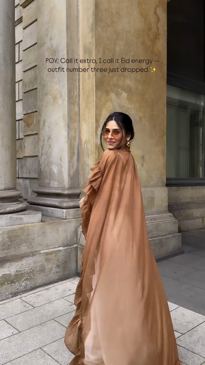 Ruffled cape-style top paired with wide-leg pants suit