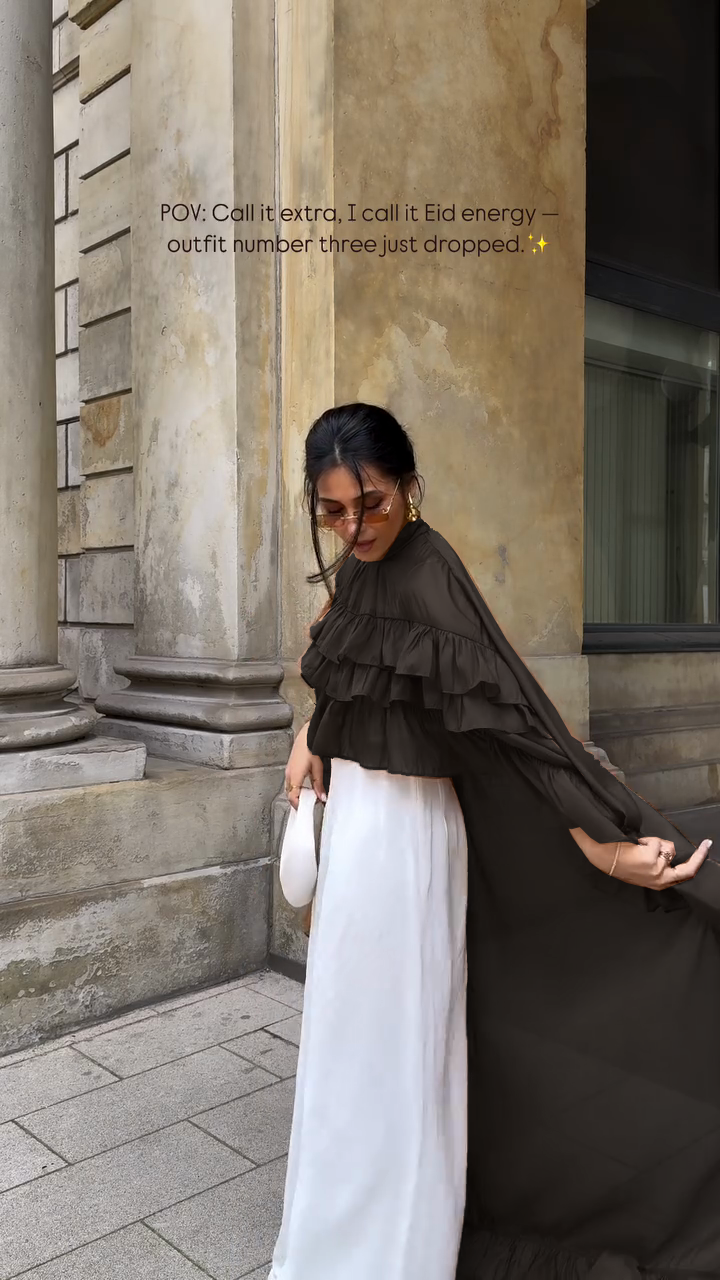 Ruffled cape-style top paired with wide-leg pants suit