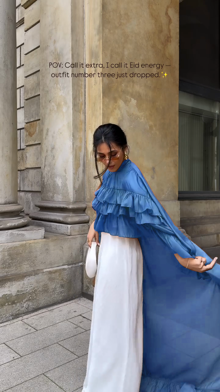 Ruffled cape-style top paired with wide-leg pants suit