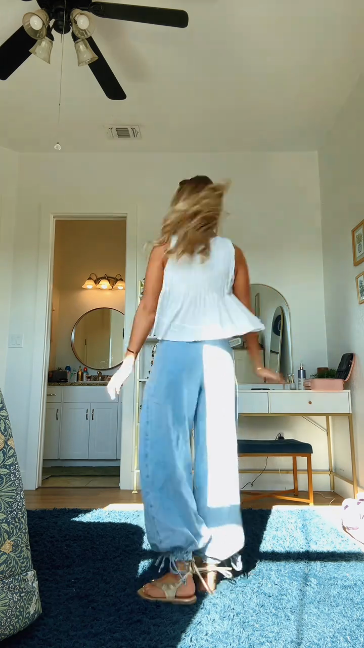 White ruffled top and light-colored loose-fitting jeans set