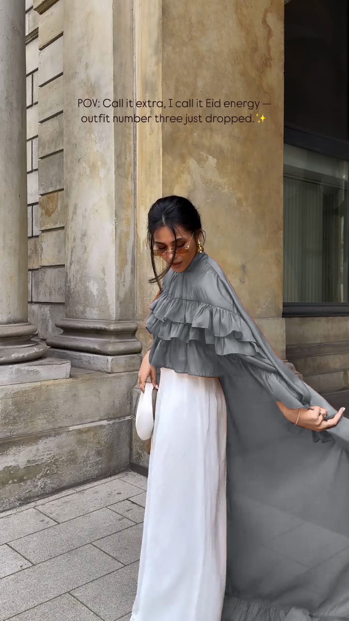 Ruffled cape-style top paired with wide-leg pants suit