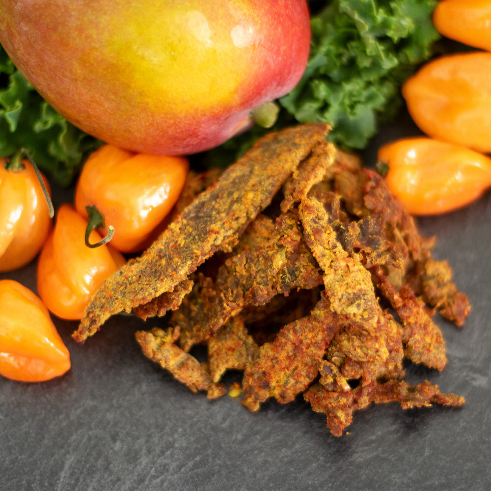 Close-up of Mango Habanero Ale Boozy Jerky, showcasing tender brisket with a rich glaze, infused with mango blonde ale and habanero spice for a bold, flavorful kick.