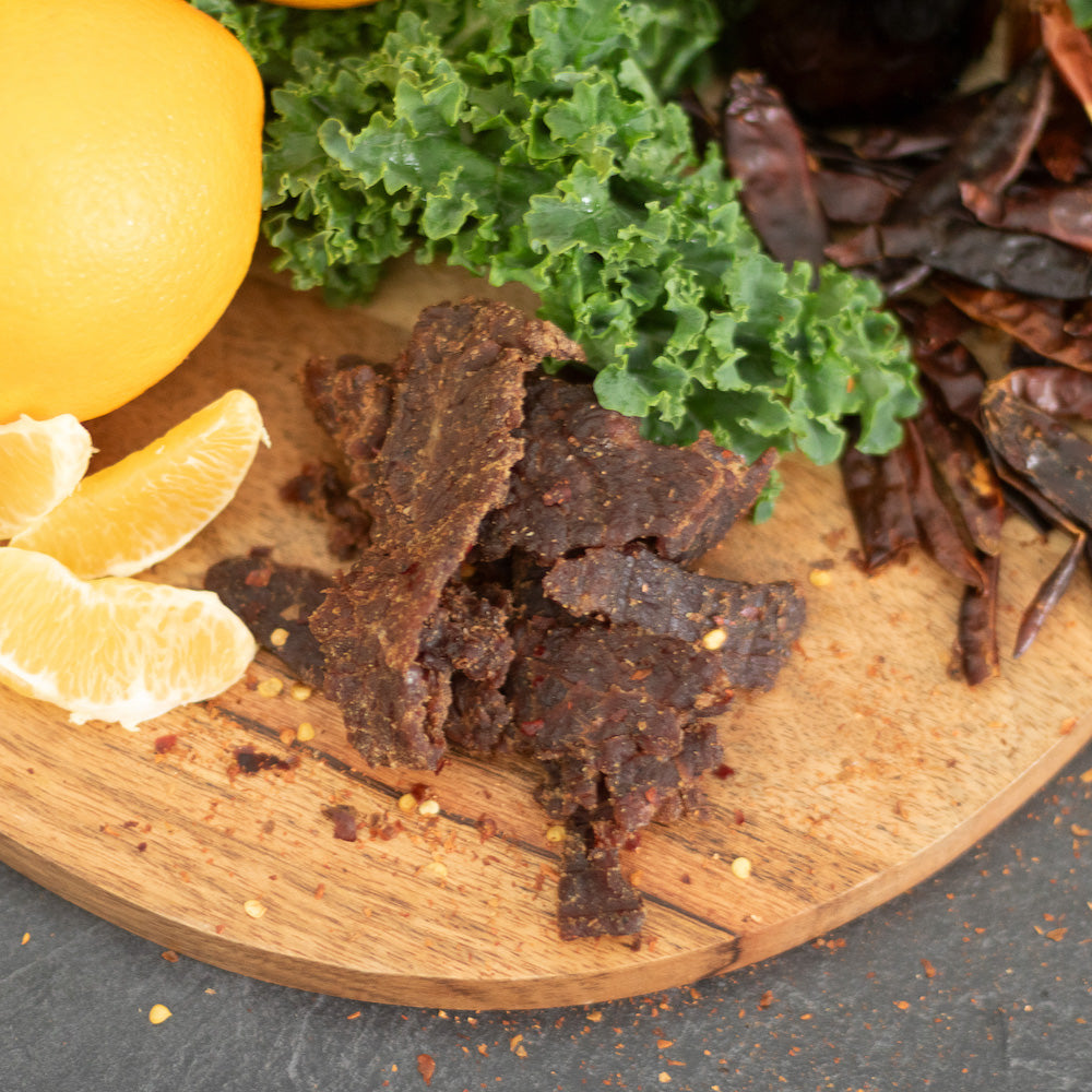 "Spicy Citrus IPA Brisket Jerky – Tender beef jerky infused with bold IPA flavors, zesty citrus, and a spicy kick. Perfectly crafted for beer lovers, this high-protein, low-carb snack pairs with IPAs, Wheat Beers, and Belgian Ales."







