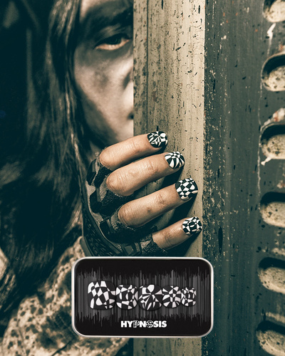 spooky Halloween themed image showcasing press on nails with a black and white geometric design
