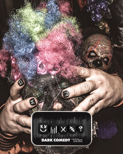spooky halloween themed image of a man wearing the dark comedy press on nail set featuring raised 3D graphic designs set on a black base