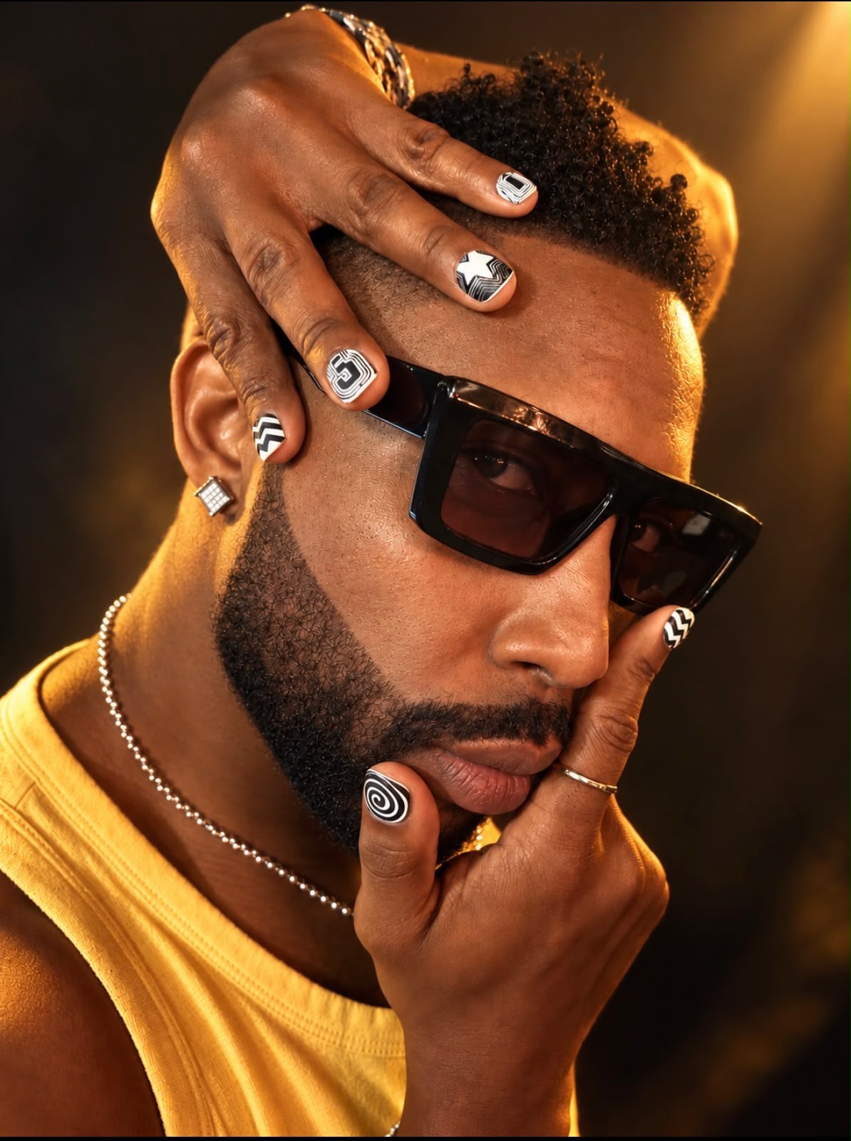 male model showcasing press on nail set featuring various black and white designs that are part of the super sketchy nail set