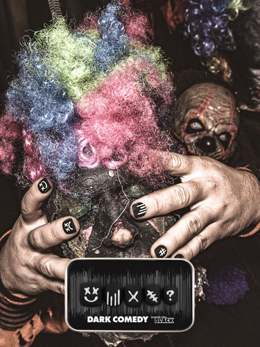 spooky halloween themed image of a man wearing the dark comedy press on nail set featuring raised 3D graphic designs set on a black base