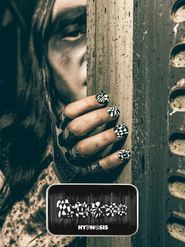 spooky Halloween themed image showcasing press on nails with a black and white geometric design