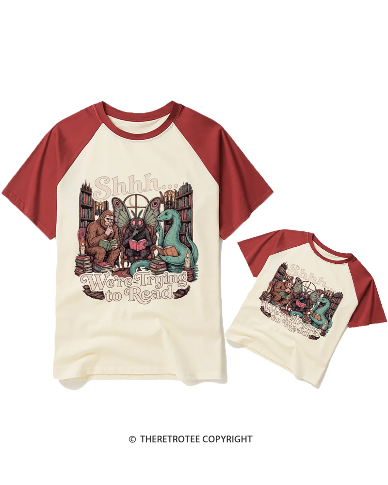 TheRetroTee Shhh We're Trying to Read Cryptid 1970s Raglan Baseball Family T-Shirt