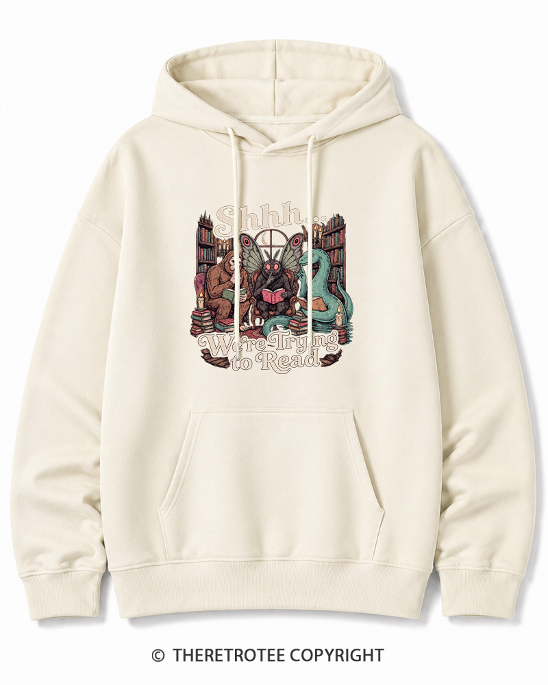 TheRetroTee Shhh We're Trying to Read Cryptid 1970s Halloween Cotton Hoodie