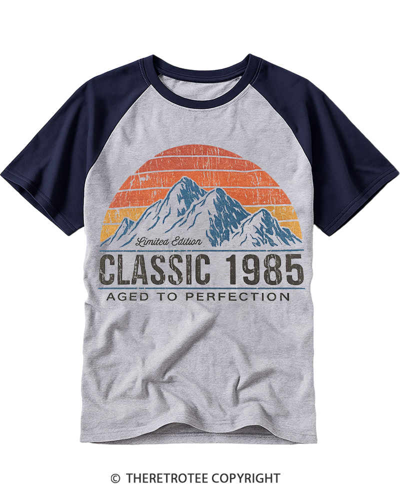 TheRetroTee 1985 Classic Mountain & Sunset Personalized Custom Year Raglan Baseball T-Shirt