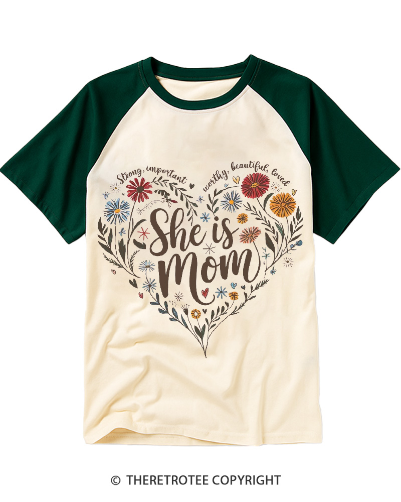 TheRetroTee She Is Mom Heart Floral Design 1970s Raglan Baseball T-Shirt