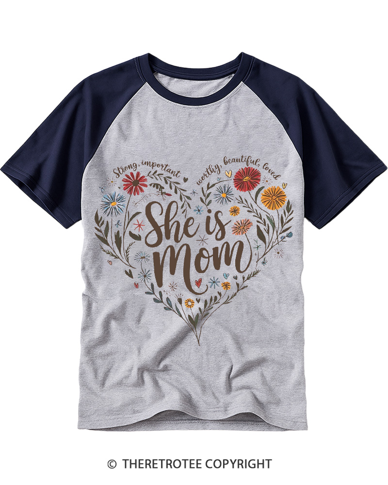 TheRetroTee She Is Mom Heart Floral Design 1970s Raglan Baseball T-Shirt