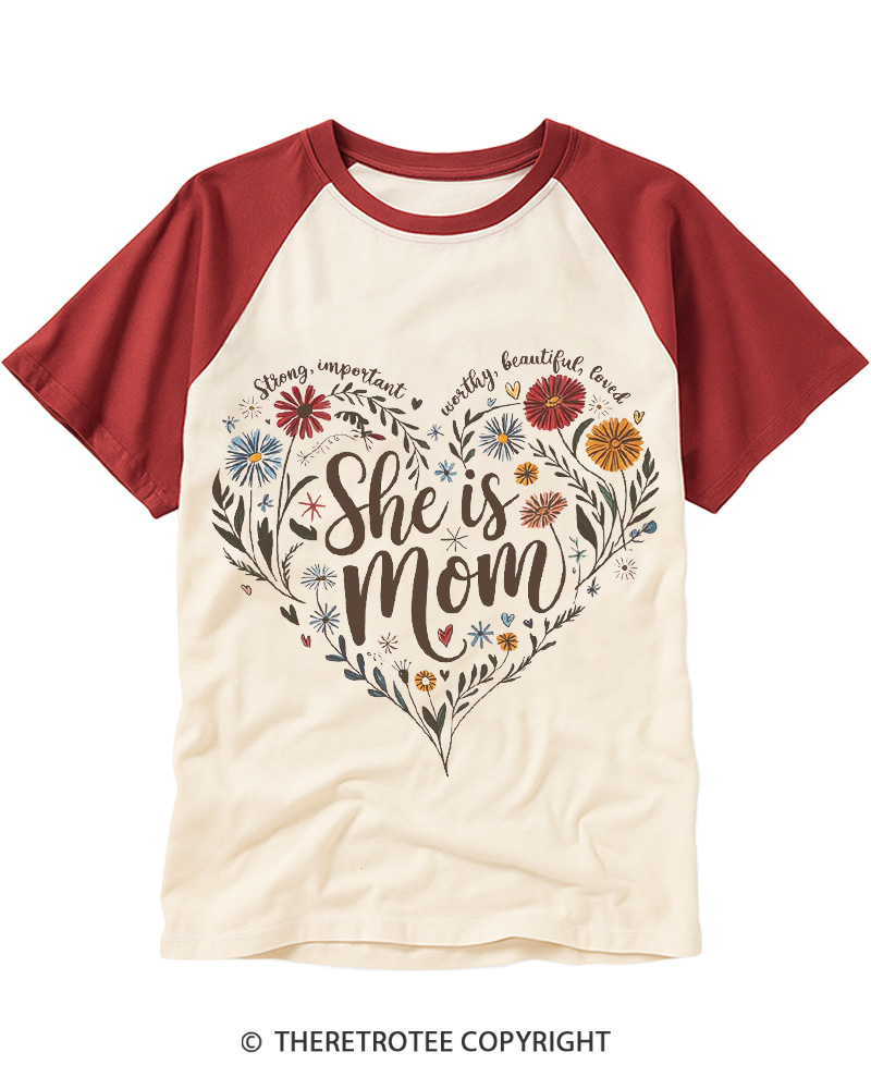 TheRetroTee She Is Mom Heart Floral Design 1970s Raglan Baseball T-Shirt