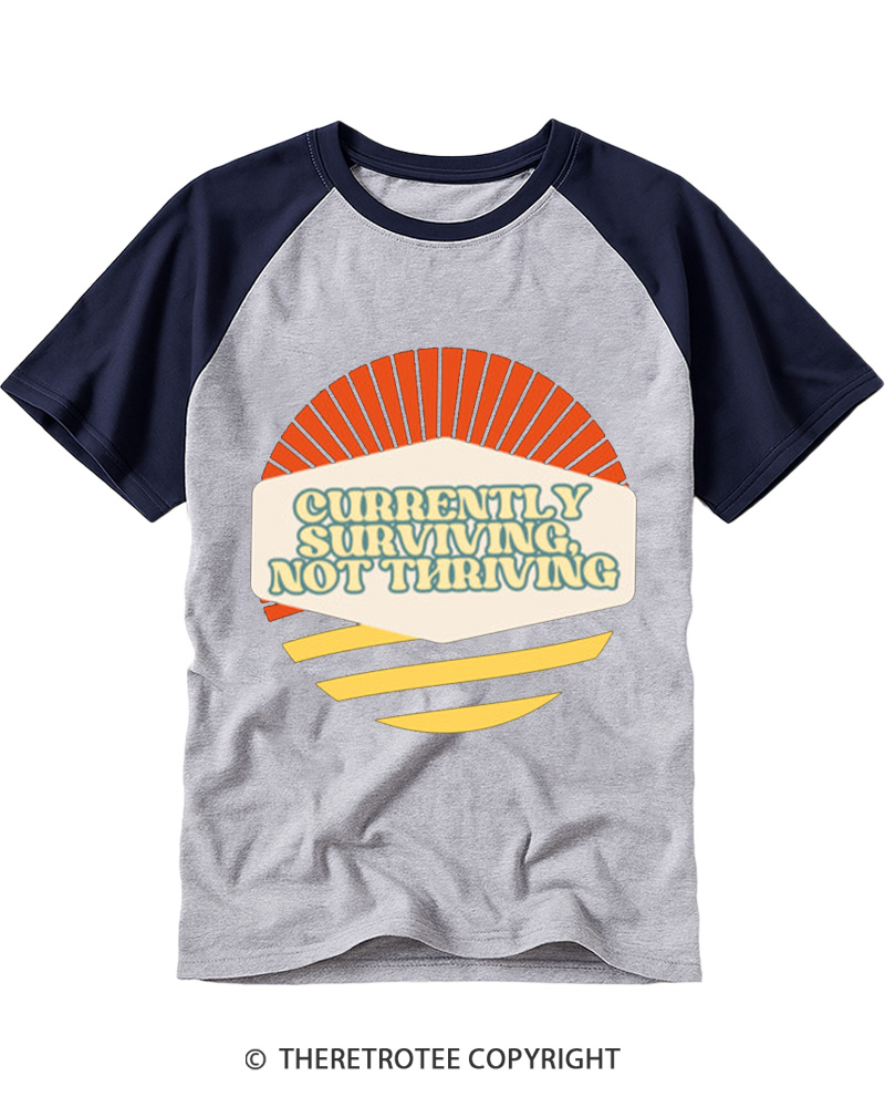 TheRetroTee Currently Surviving Not Thriving Raglan Baseball T-Shirt