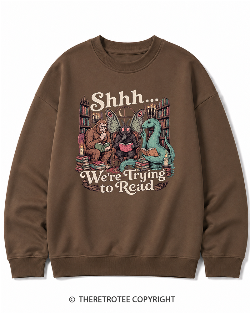 TheRetroTee Shhh We're Trying to Read Cryptid 1970s Halloween Cotton Sweatshirt