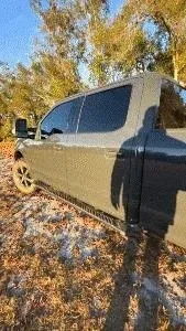 Headrest gun rack installed in vehicle showing secure rifle storage