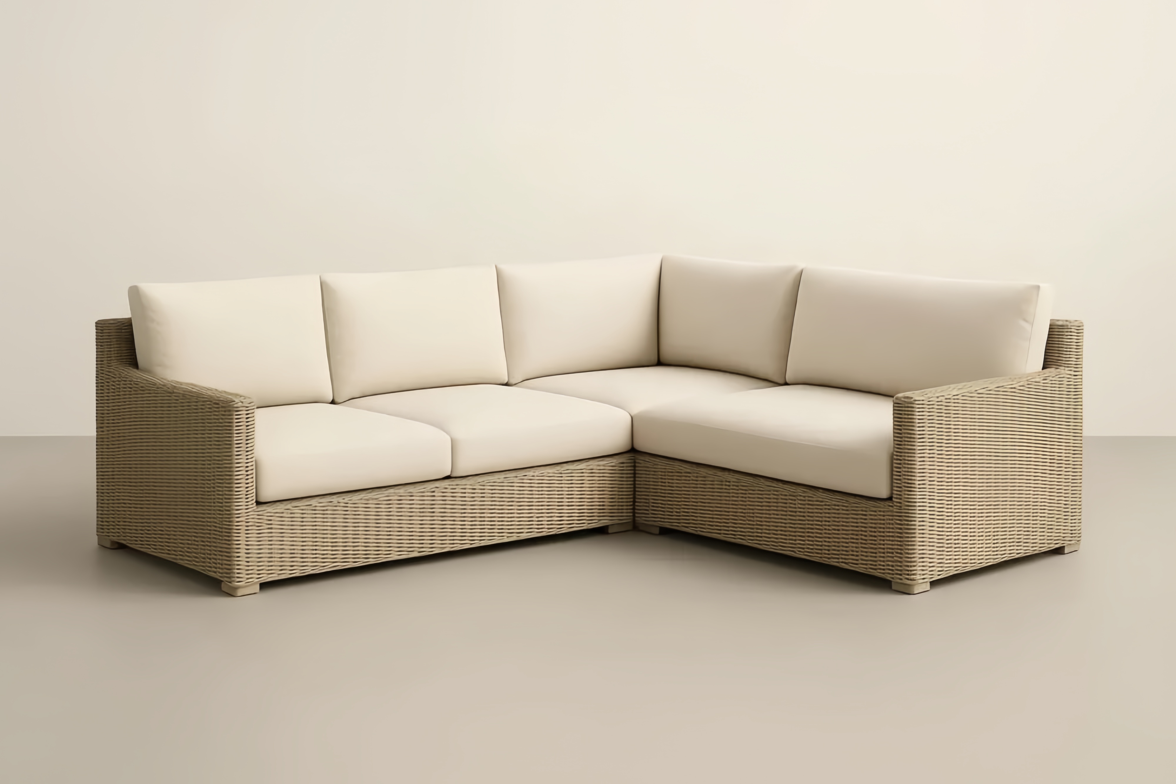 Divano angolare in rattan intrecciato con cuscini in poliestere crema