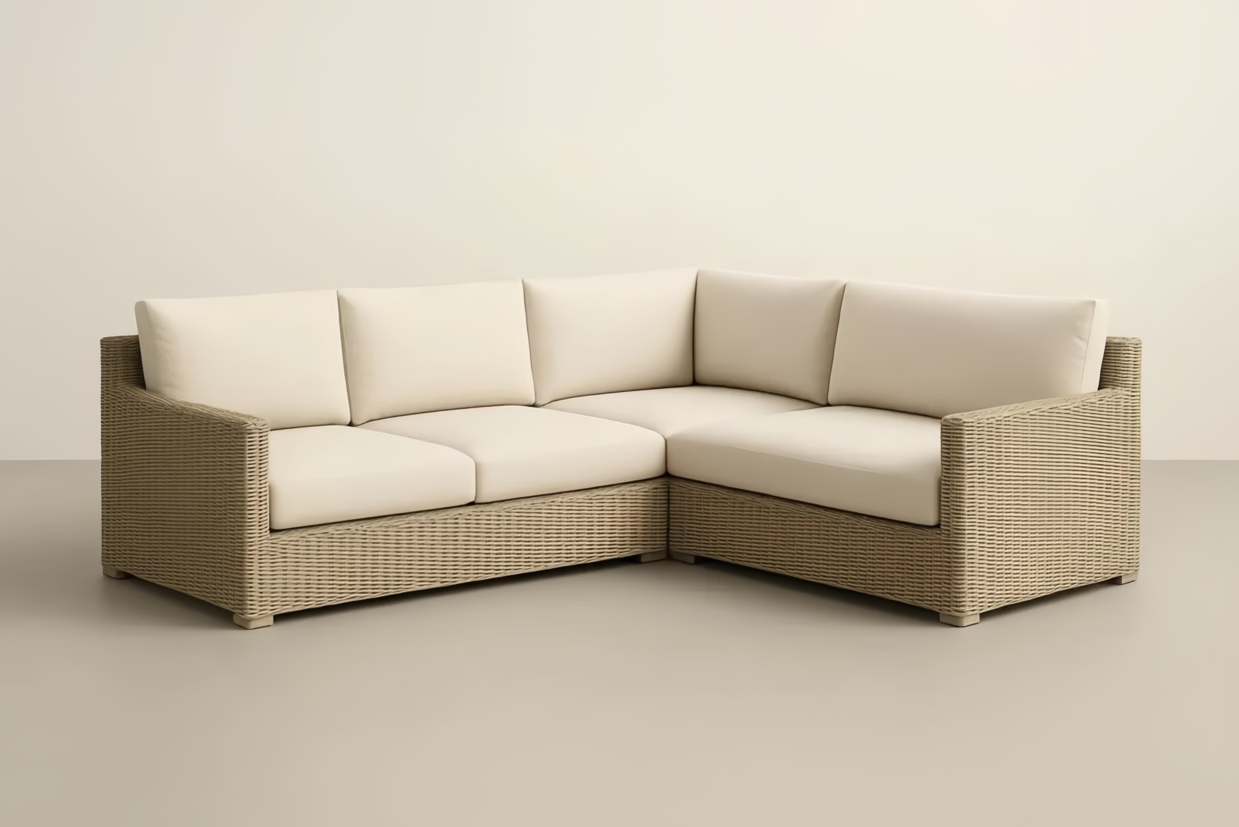 Divano angolare in rattan intrecciato con cuscini in poliestere crema