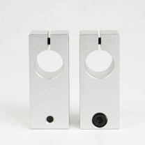 Two upright aluminum cross shaft clamps with socket-head screws