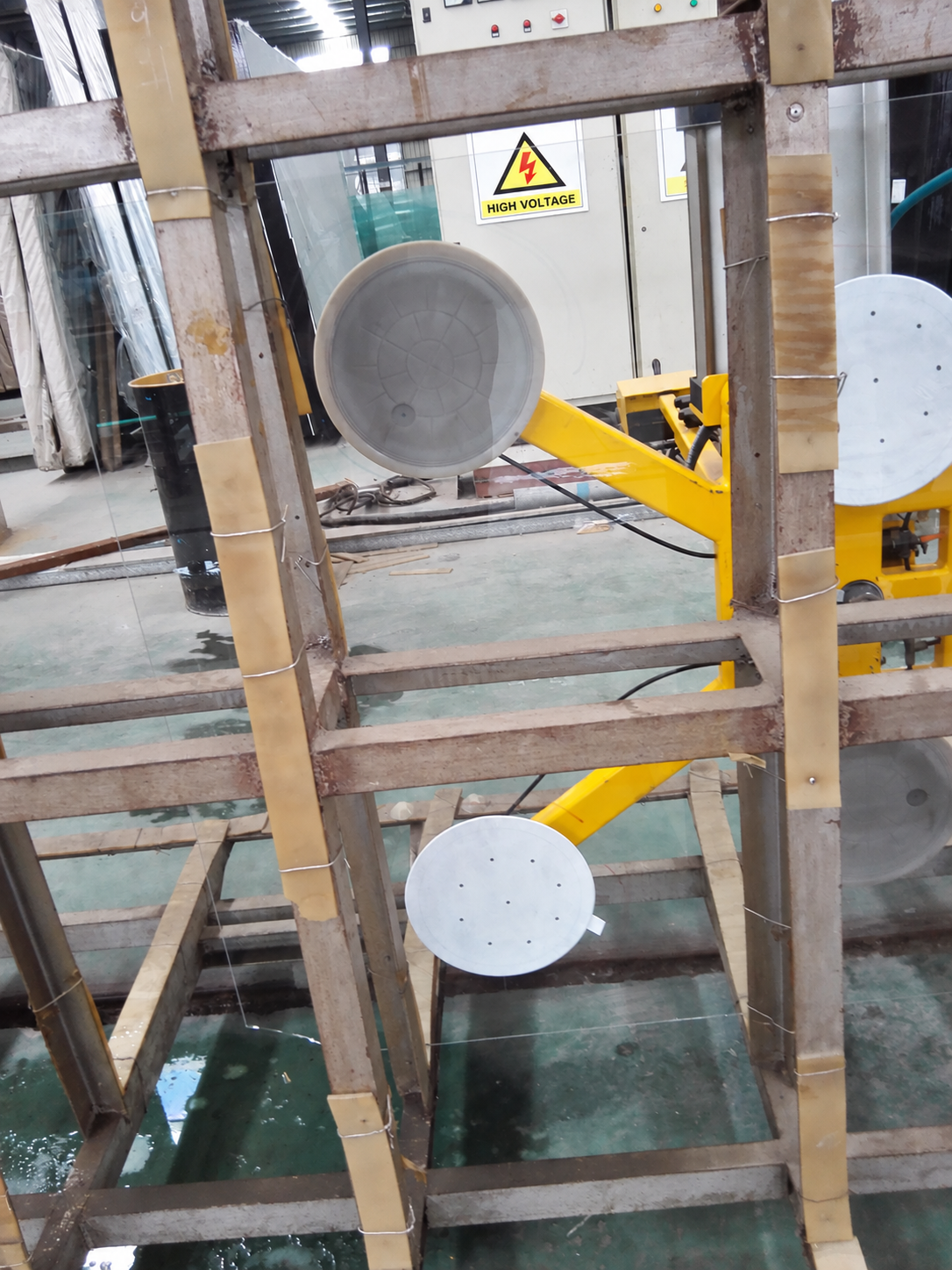 Close-up of fabric-covered vacuum cups on industrial glass handling equipment