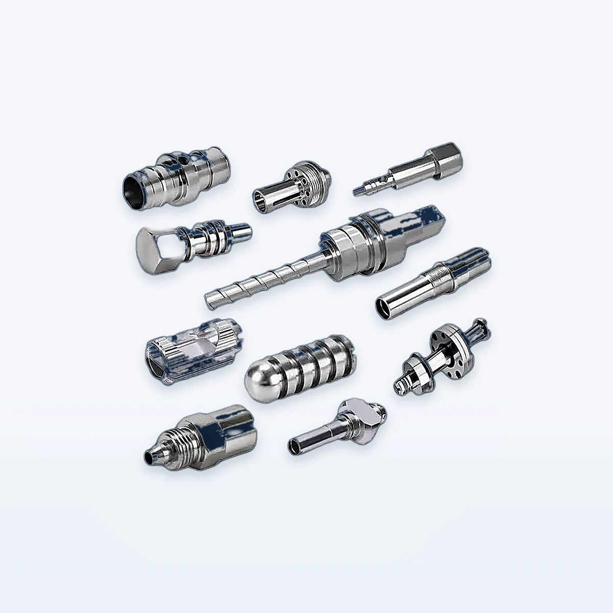 Custom CNC-turned shafts, sleeves and fittings arranged on a light studio background