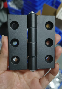Original handheld multi-hole hinge photograph — family reference, not a dimensional drawing or supplied quantity