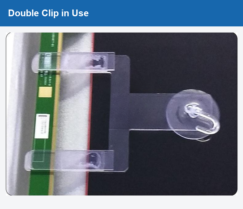 Original photograph of a double clip positioned beside a circuit board.