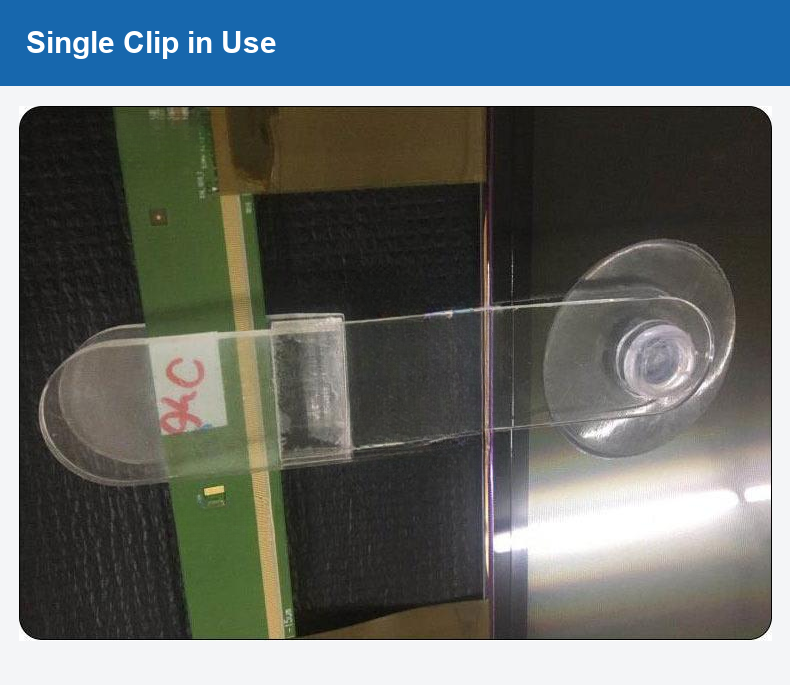 Original photograph of a single clip positioned beside a circuit board.