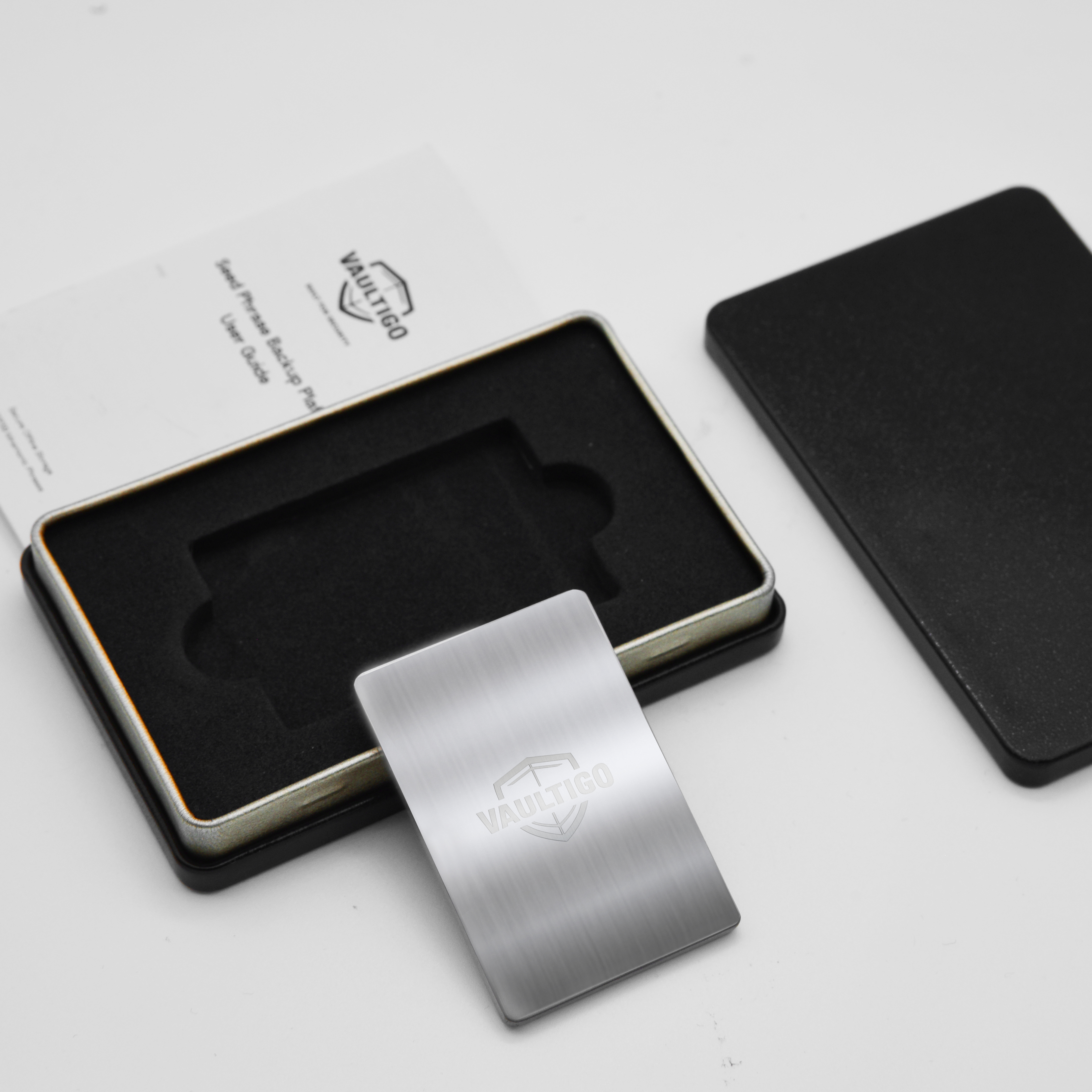 Vaultigo titanium rectangle seed phrase backup plate open gift box with product
