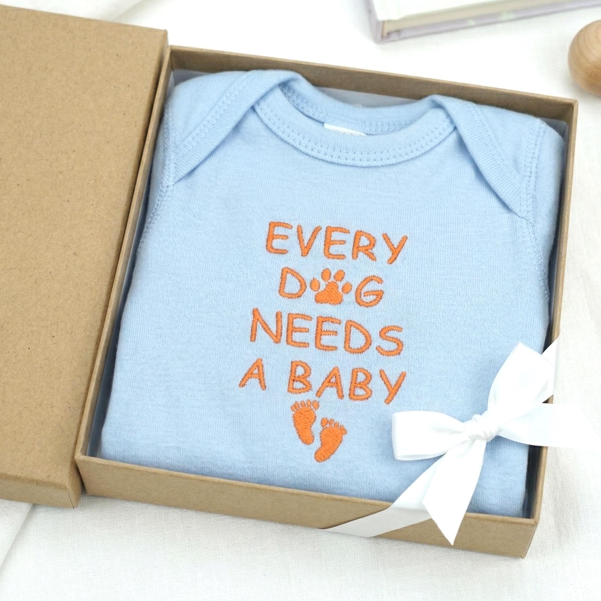Every Dog Needs A Baby Embroidered Onesie