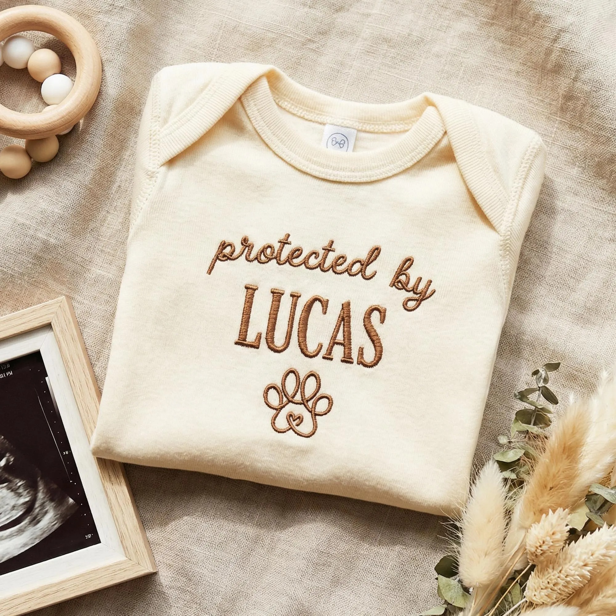 Protected by Baby Onesie - Custom Embroidered Pet Name Onesie
