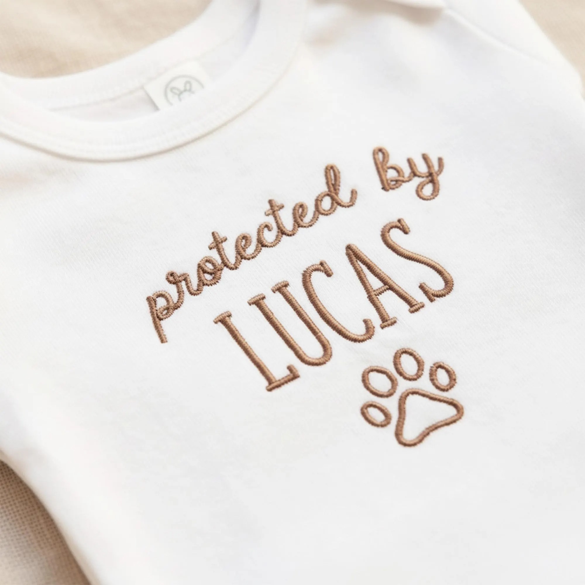 Protected by Baby Onesie - Custom Embroidered Pet Name Onesie