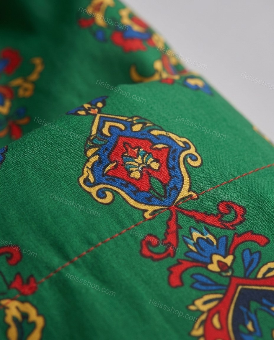 Green Midi Dress, close-up of red and blue accents, border print hem and ornate multicolor pattern, by Rieissshop