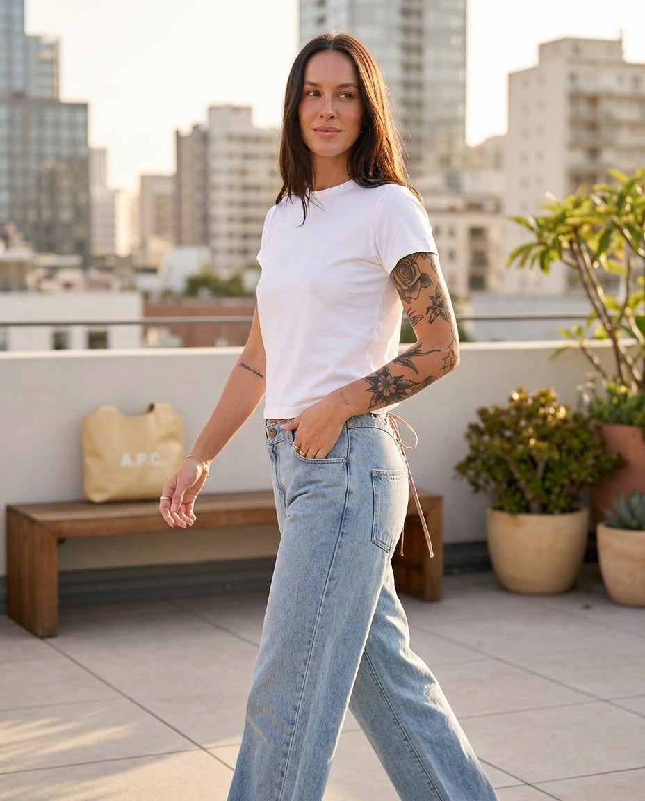 Light Wash Denim Bloom Summer Lace Romper Light Wash Denim Romper with Wide-Leg silhouette and Textured texture, outdoor styling image for Wedding Guest, an estate dinner at golden hour, US East / Hamptons Elite by Mesadic