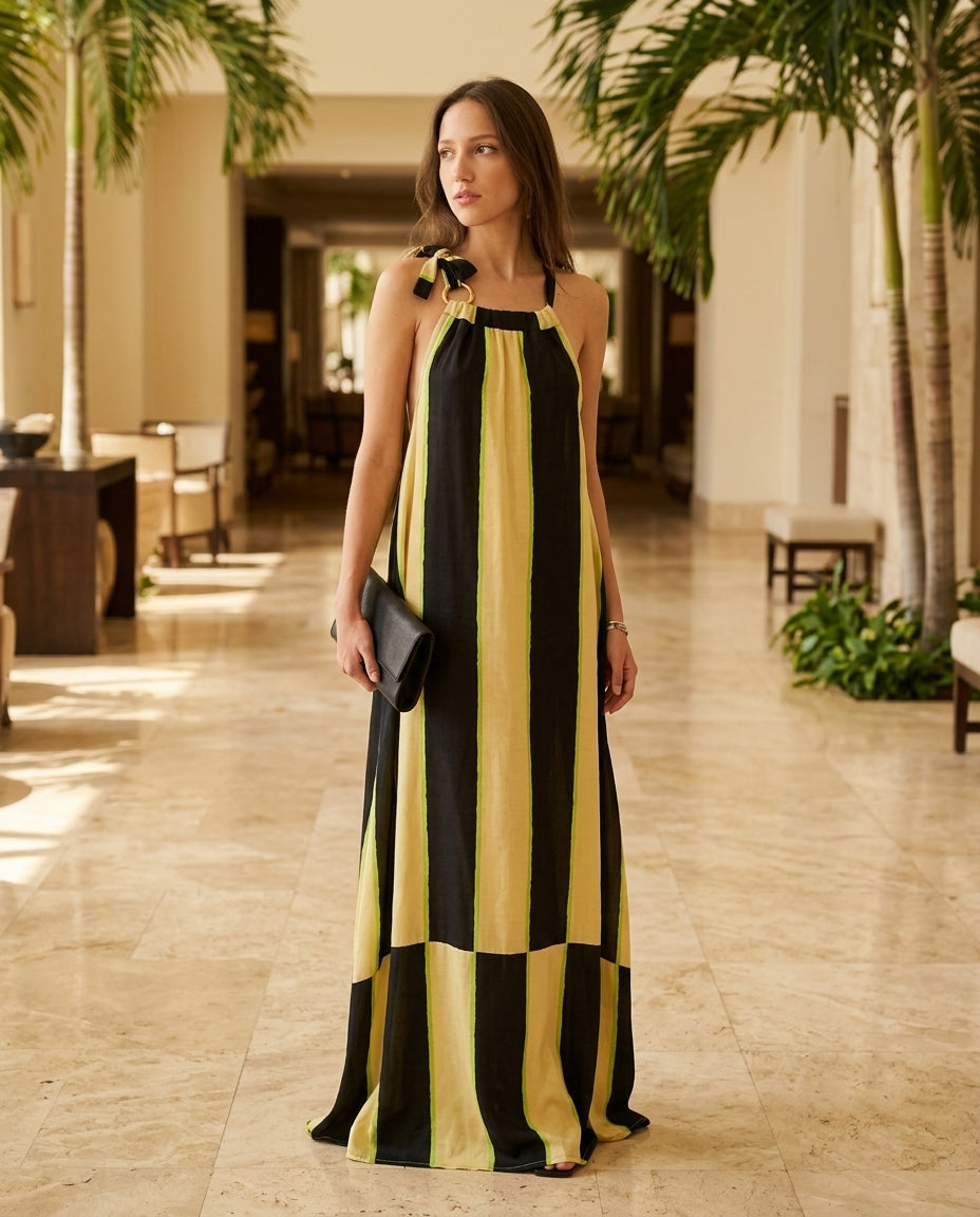 Black Grace Resort Striped Romper Black Romper with Relaxed Fit silhouette and Satin texture, editorial ecommerce scene for Resort Wear, an estate dinner at golden hour, US East / Hamptons Elite by Mesadic
