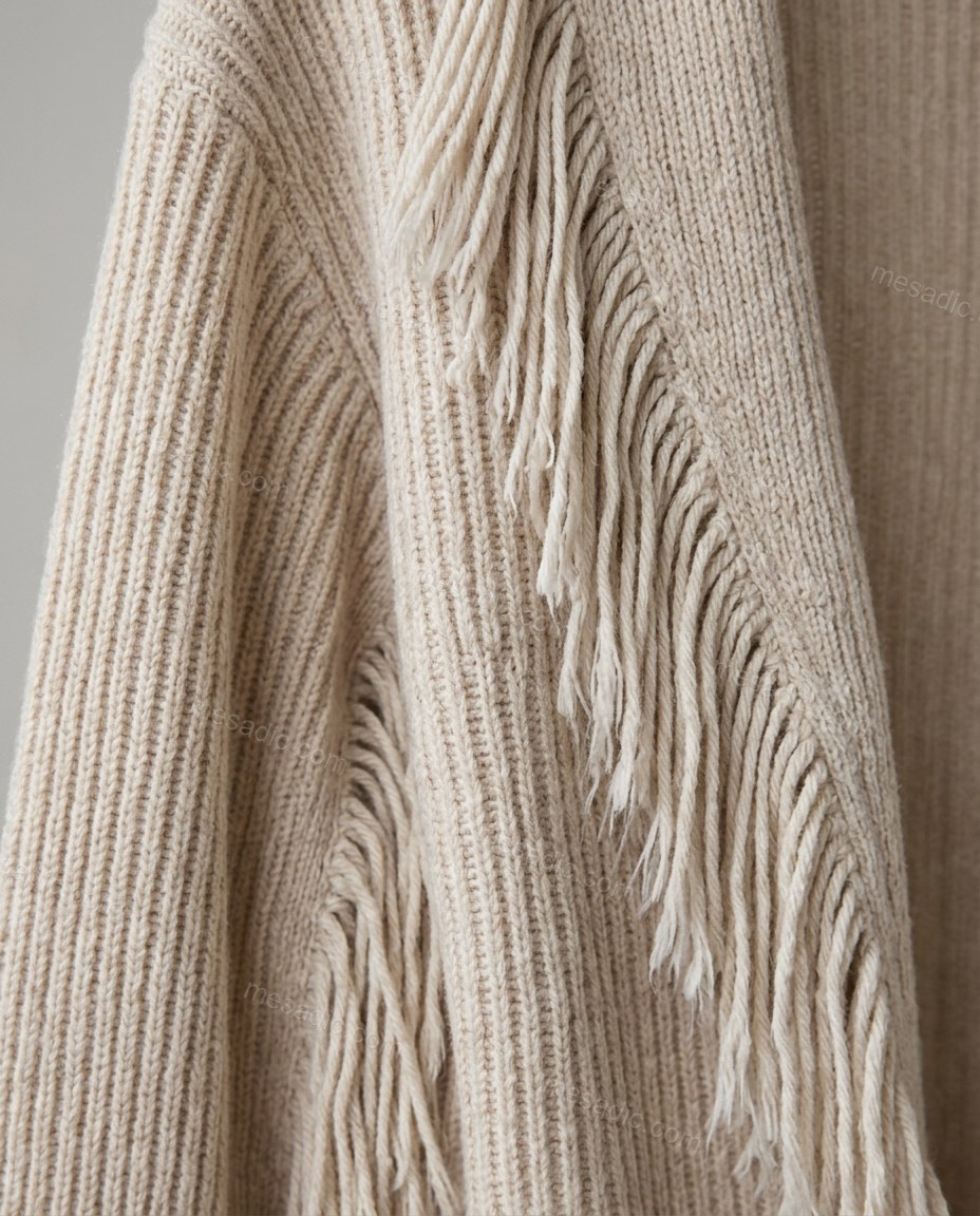 Beige Fringe Knit Ribbed Cardigan, close-up of fringe trim along sleeves and back hem, ribbed knit texture and open front, by mesadic.com