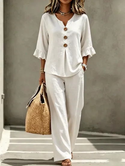 A women's set consisting of a ruffled sleeve top and wide-leg trousers.
