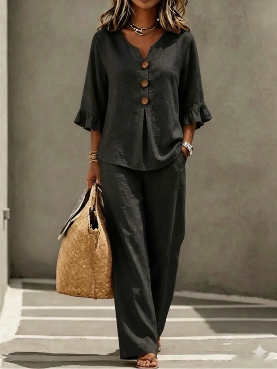 A women's set consisting of a ruffled sleeve top and wide-leg trousers.