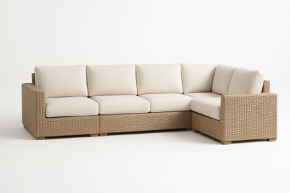 Divano angolare modulare in vimini con cuscini in tessuto crema