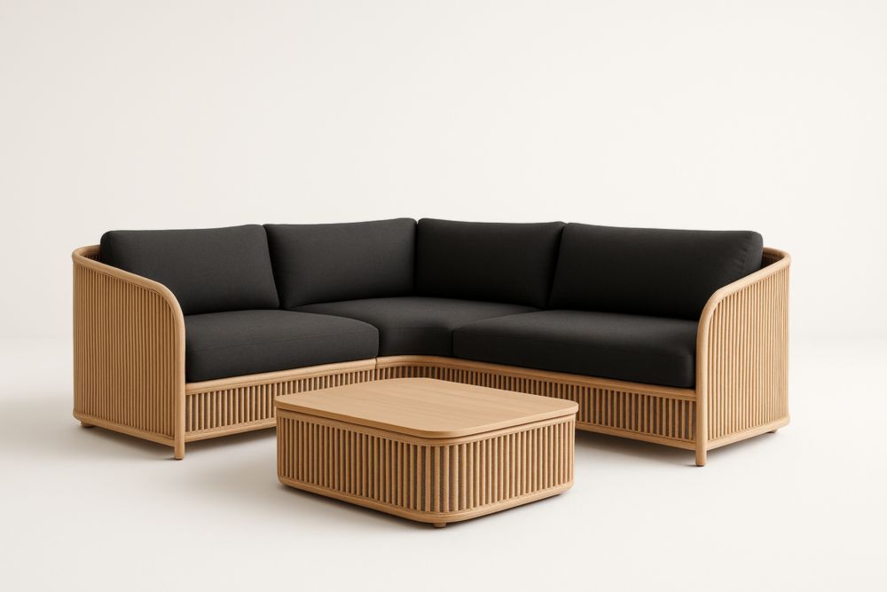 Divano angolare in tessuto nero con struttura in rattan e tavolino